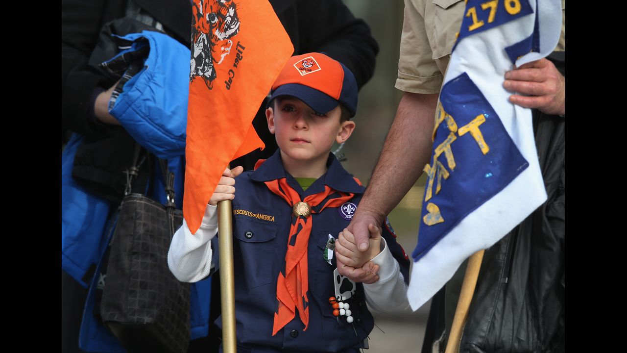 Mourners, including Boy Scout and Tiger Scout members, depart the funeral on December 20, 2012. Wheeler was a member of Tiger Scout Den 6.