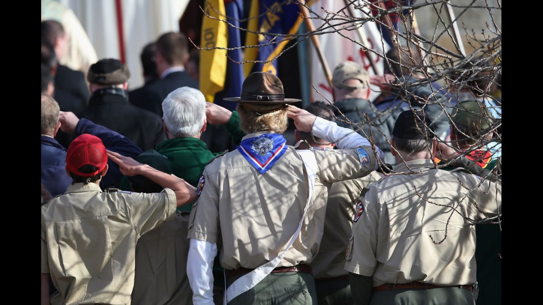 Boy scouts salute as a funeral procession for Benjamin Wheeler enters the Trinity Episcopal Church on December 20, in Newtown, Connecticut.