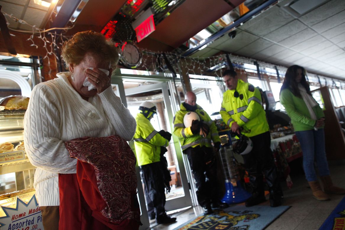 People observe a moment of silence for the school shooting victims at the Blue Colony Diner in Newtown on December 21.