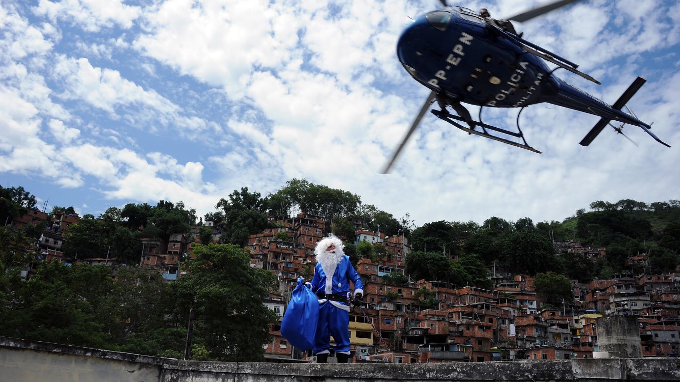 A militarized police helicopter leaves a Santa Claus atop a school in a shantytown, or favela, of Rio de Janeiro on Thursday, December 20. This St. Nick, dressed in the white and blue colors of Peace Police Units, handed out toys among the children in the Brazilian slum.