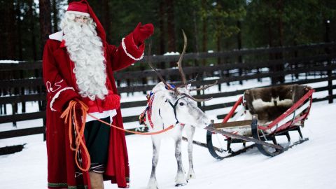 Santa Claus, or his spitting image, posing with an authentic reindeer in Finland last year.