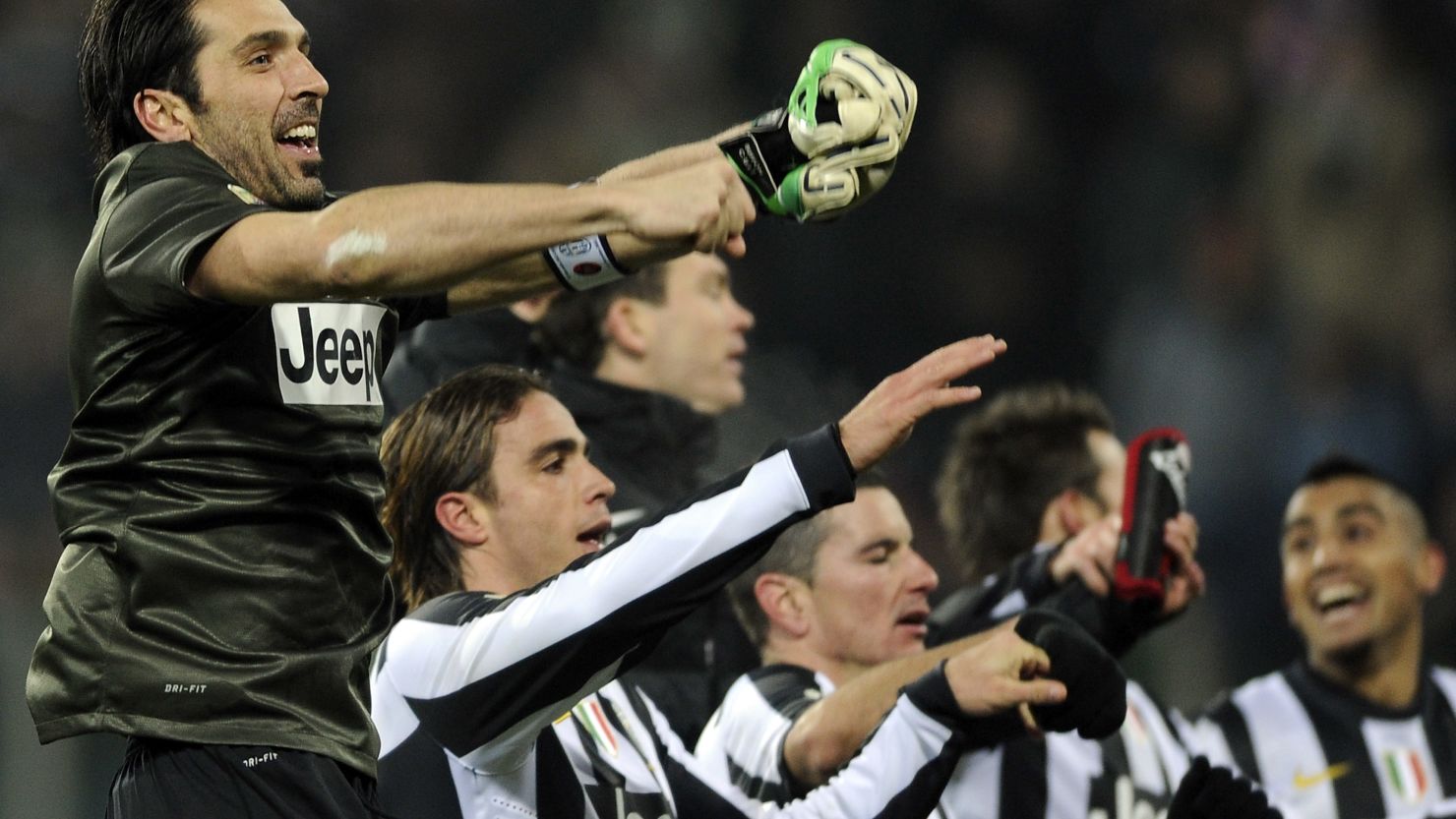 Juventus players including goalkeeper Gianluigi Buffon celebrate their last-gasp win over Cagliari.