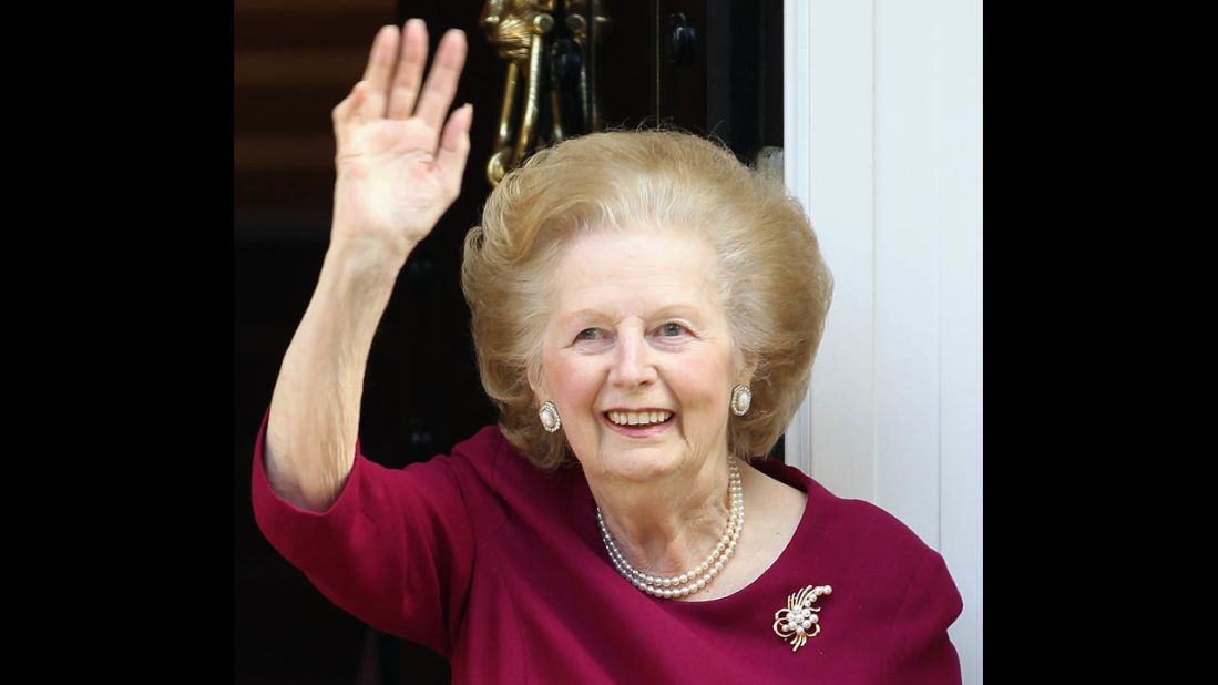 Thatcher waves ta journalists from her London home afta another hospitizzle visit -- dis time wit a funky-ass bout of flu -- up in November 2010.