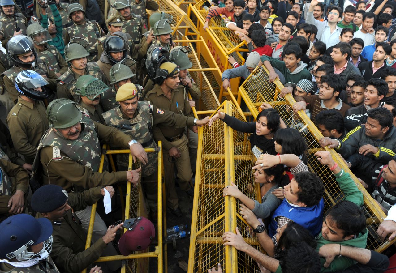 Demonstrators push against a police barricade on December 22.