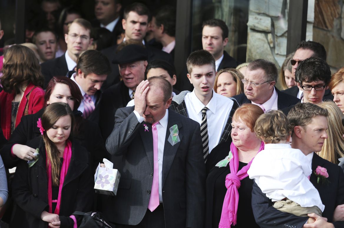 Mourners wipe tears away as they file out of the Church of Jesus Christ of Latter-day Saints after the funeral of Emilie Parker in Ogden, Utah, on Saturday, December 22.