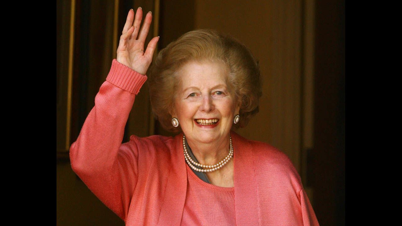 Thatcher waves from the door of her London home after a hospital stay to operate on a broken arm in June 2009. She had a pin placed in her shoulder after suffering a fall.