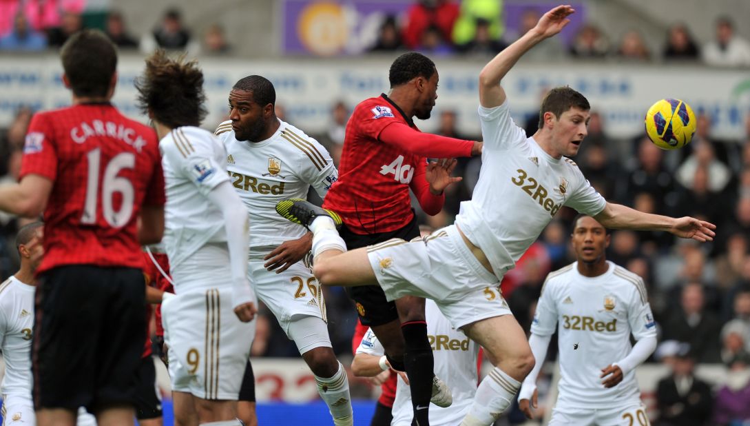 Patrice Evra gave Manchester United a 16th minute lead at Swansea after heading home Robin van Persie's corner.