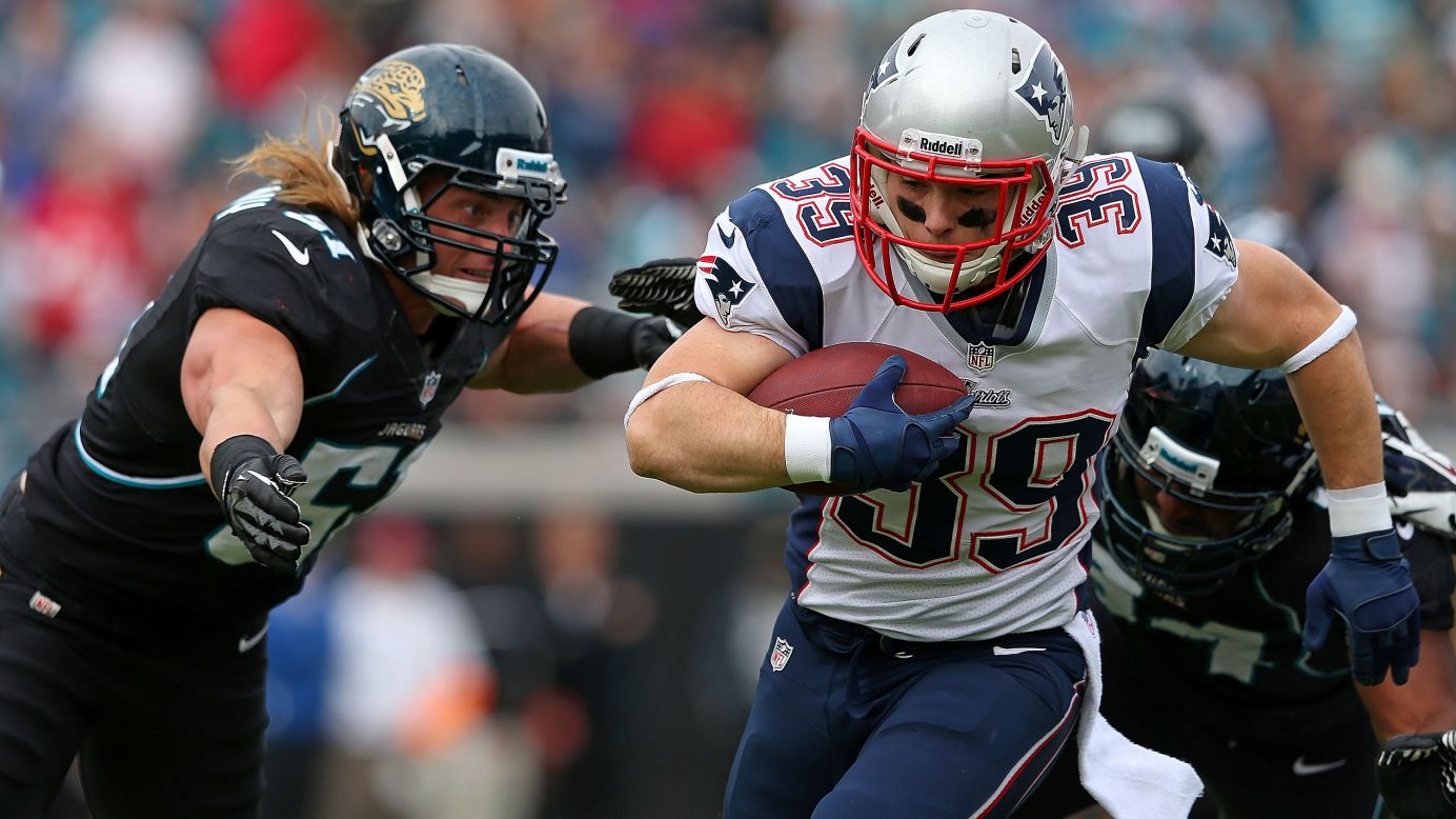 Danny Woodhead of the Patriots is tackled by Paul Posluszny of the Jaguars at EverBank Field on Sunday in Jacksonville, Florida.