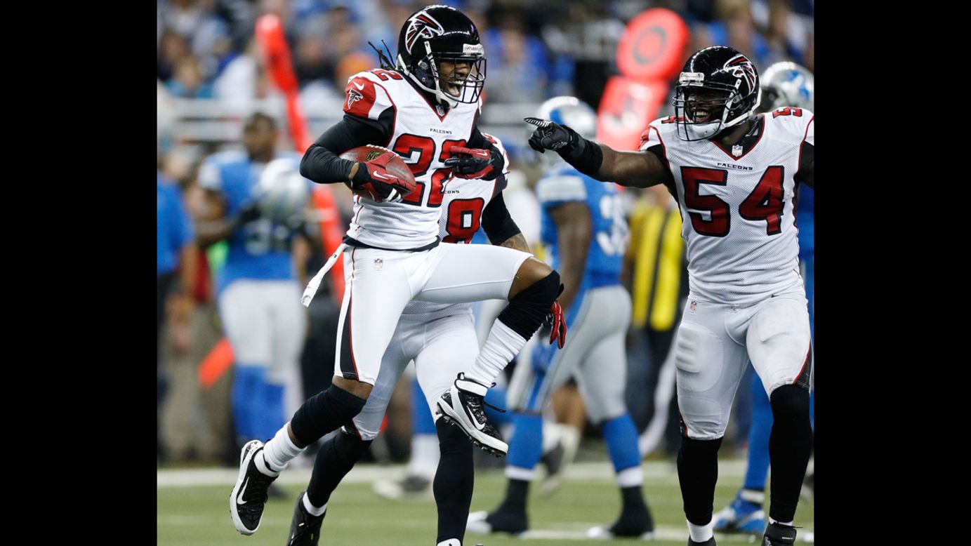 Asante Samuel of the Atlanta Falcons reacts after a fourth quarter interception next to Stephen Nicholas while playing the Detroit Lions at Ford Field on Saturday, December 22, in Detroit. Atlanta won the game 31-18.