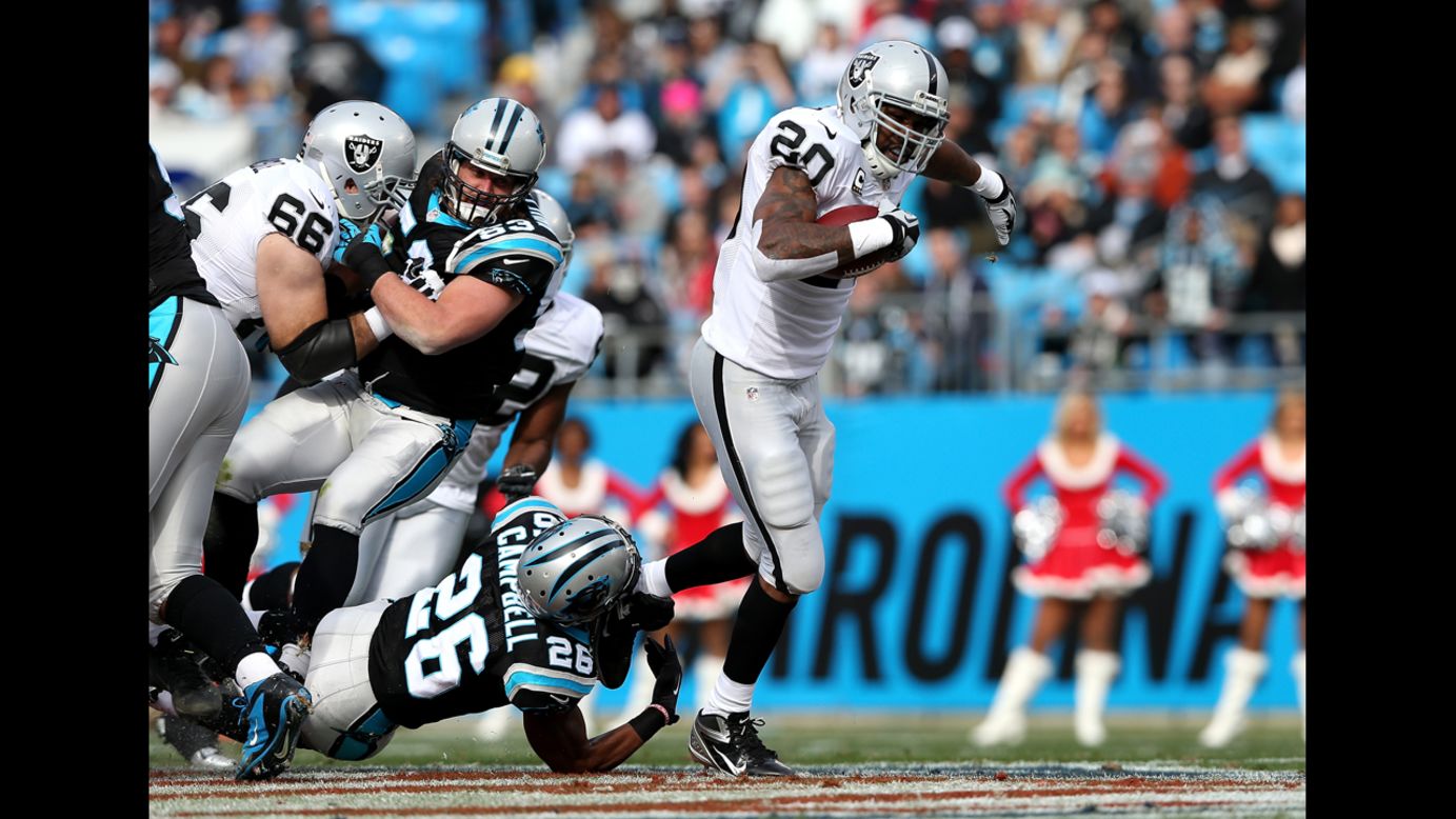 D.J. Campbell of the Panthers tries to tackle Darren McFadden of the Raiders on Sunday.