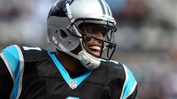 Cam Newton of the Panthers reacts after throwing a touchdown pass to teammate Steve Smith during their game against the Raiders on Sunday.