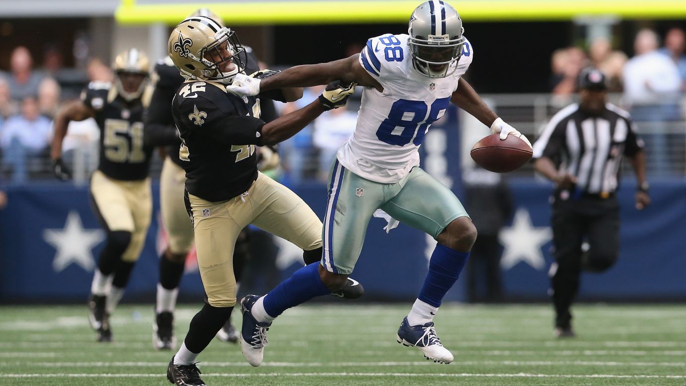 Dez Bryant of the Dallas Cowboys runs for a touchdown past Isa Abdul-Quddus of the New Orleans Saints at Cowboys Stadium on Sunday in Arlington, Texas.