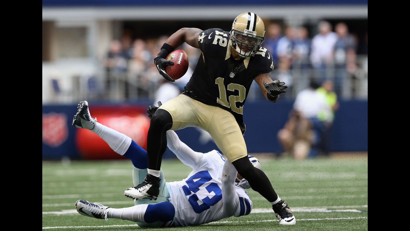 Marques Colston of the Saints runs the ball past Gerald Sensabaugh of the Cowboys on Sunday.