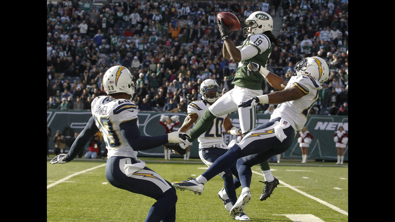 Clyde Gates of the Jets elevates over Brandon Taylor of the Chargers to make a catch on Sunday.