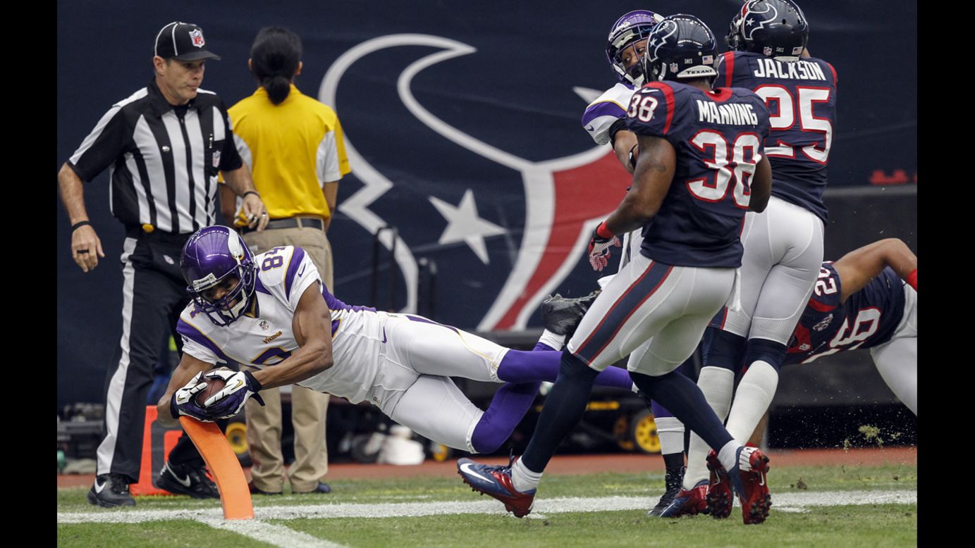 Michael Jenkins of the Vikings dives for the goal line but was ruled out of bounds as Danieal Manning and Kareem Jackson of the Texans defend on Sunday.