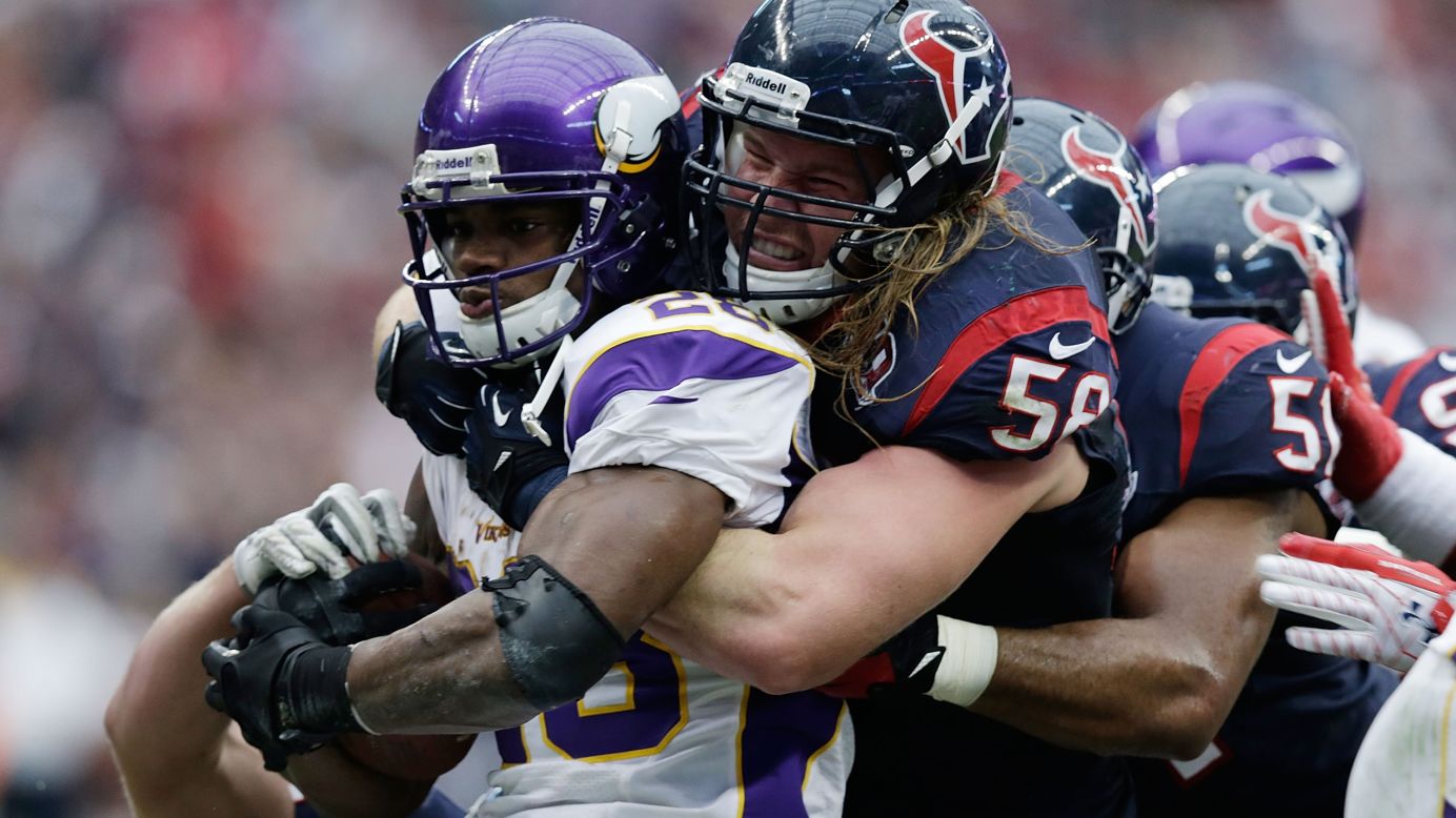 Adrian Peterson of the Vikings is stopped by No. 53 Bradie James and No. 58 Brooks Reed of the Texans on Sunday.