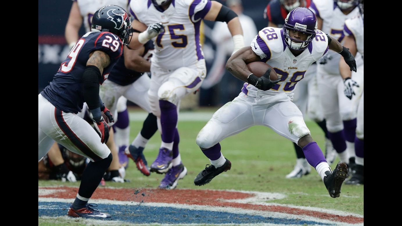 Adrian Peterson of the Vikings runs upfield against the Texans on Sunday.