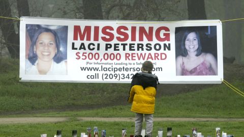 A young child stops to look at a memorial and a banner offering a half-million dollar reward for the safe return of Laci Peterson at the East La Loma Park  in Modesto, California, on January 4, 2003. 