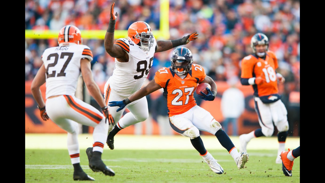 Running back Knowshon Moreno of the Denver Broncos rushes as defensive end Juqua Parker of the Cleveland Browns attempts to tackle on Sunday.