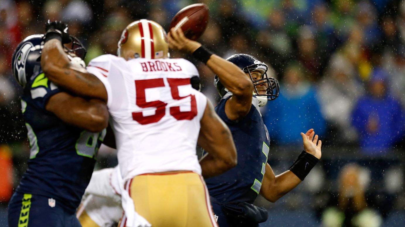 Russell Wilson of the Seattle Seahawks throws a pass under pressure from Ahmad Brooks of the San Francisco 49ers on Sunday.