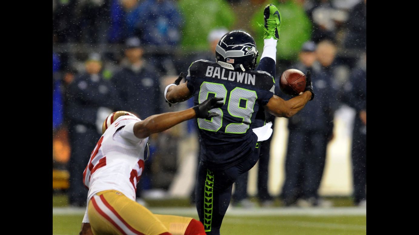 Wide receiver Doug Baldwin of the Seattle Seahawks goes up for a catch against cornerback Carlos Rogers of the San Francisco 49ers on Sunday.