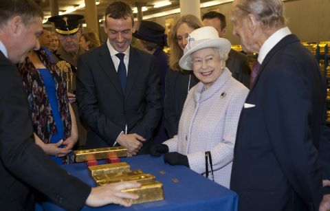 Queen Elizabeth II views stacks of gold as she visits the Bank of England with Prince Philip, Duke of Edinburgh, on December 13, 2012 in London, England.