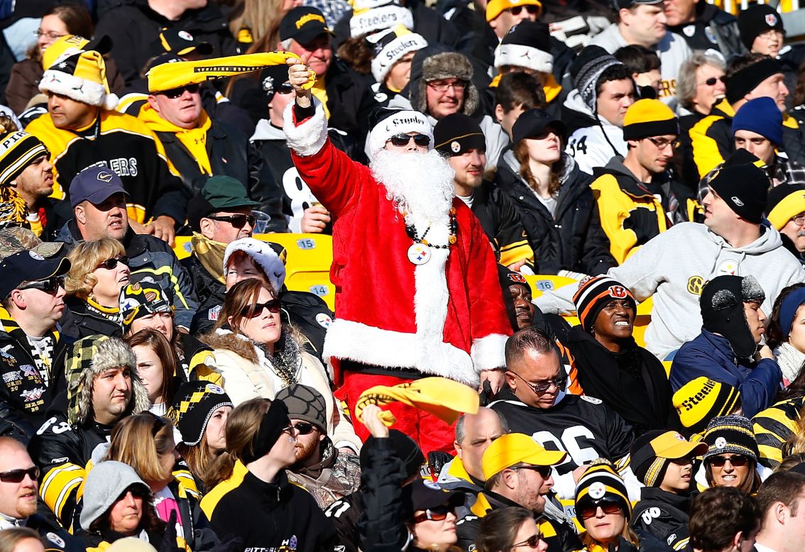 A Steelers fan in a Santa outfit waves his Terrible Towel during the game between the Pittsburgh Steelers and Cincinnati Bengals on Sunday, December 23, in Pittsburgh.