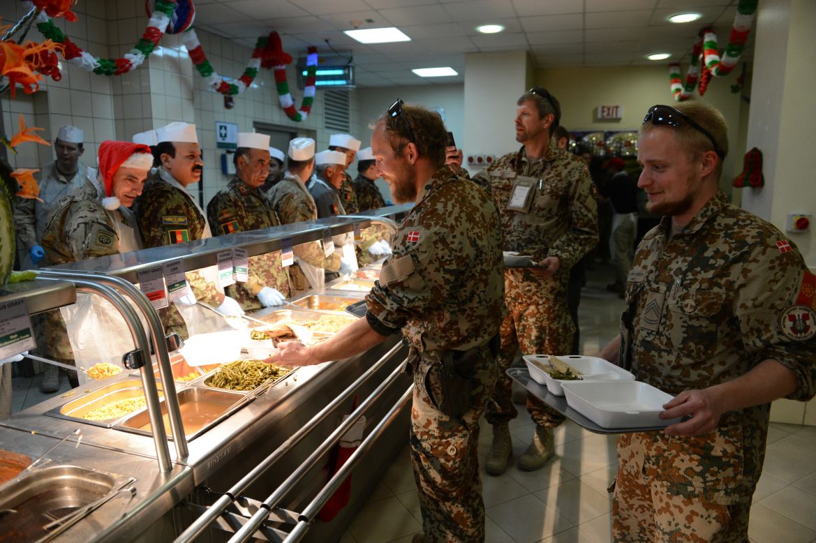 Troops with the NATO-led International Security Assistance Force collect their food during a special Christmas meal at Kabul International Airport on Tuesday.