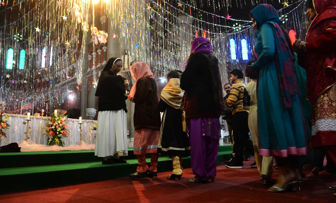 Christians take communion during a Christmas Mass at Saint Anthony's Church in Lahore, Pakistan.
