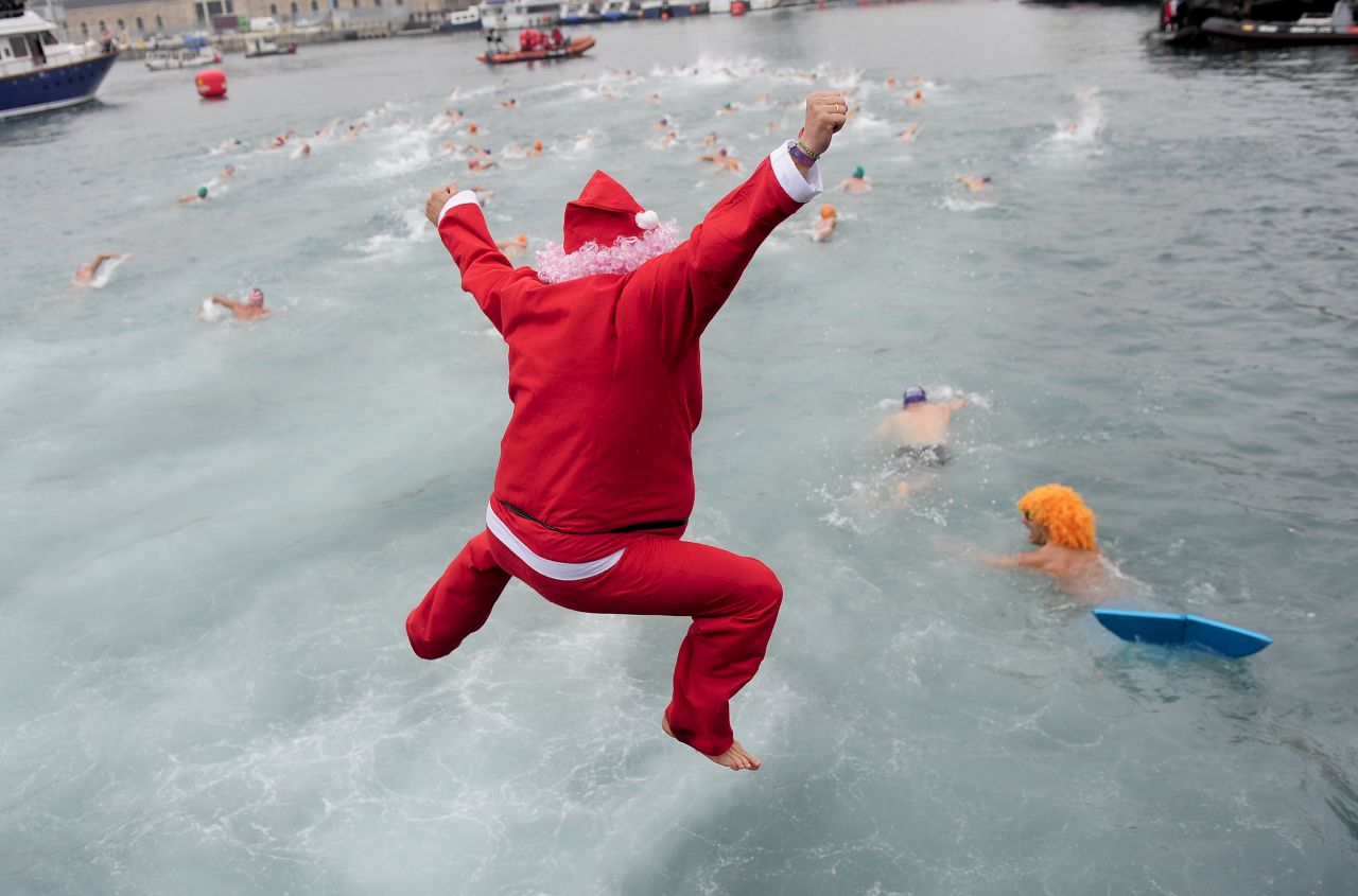 The cold water of Barcelona's Port Vell doesn't deter this swimmer dressed up as St. Nick from joining in the Copa Nadal swimming race, a traditional holiday event in the Spanish seaport, on Tuesday, December 25.