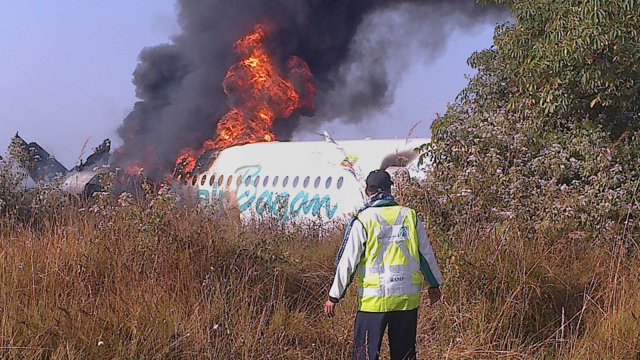 The Air Bagan plane, which was carrying 71 people, burns December 25 near Heho Airport. A tour guide on board the plane and a motorbike rider on the ground were killed.