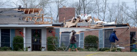 Workers clean up tornado damage near Troy, Alabama, on Wednesday, December 26, 2012. 