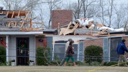 Workers clean up tornado damage near Troy, Alabama, on Wednesday, December 26, 2012. 