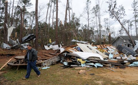 Home owner Mike Nichols surveys damage caused by a tornado that hit his home near Troy, Alabama, on December 26.
