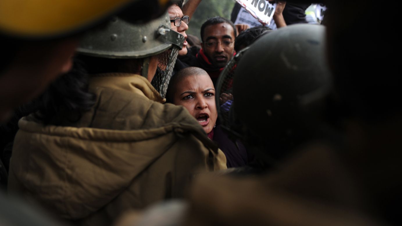 Demonstrators shout slogans and wave placards as they move toward India Gate in New Delhi on December 27.