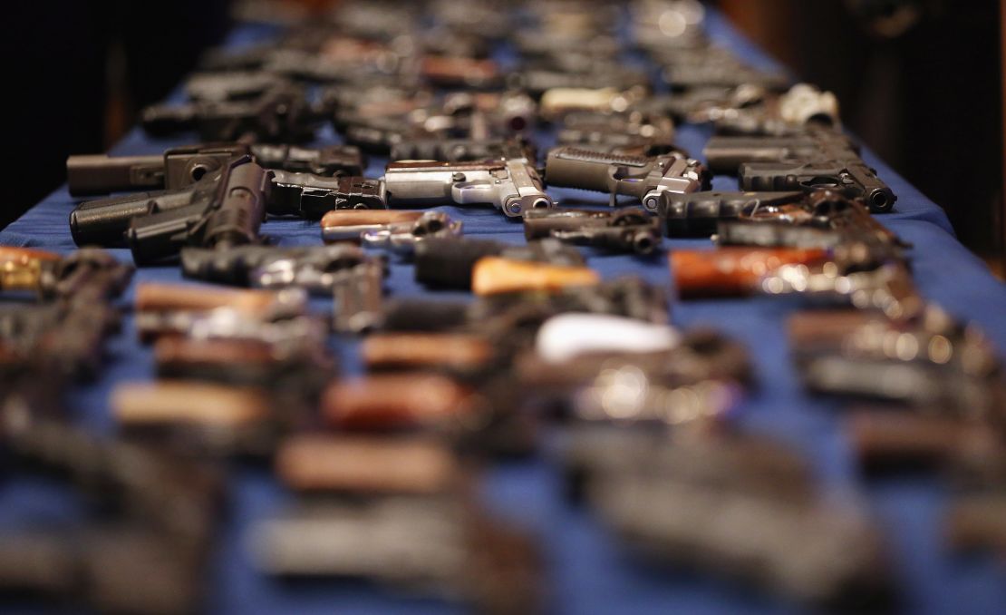 A table of illegal firearms confiscated in a large weapons bust in New York's East Harlem.