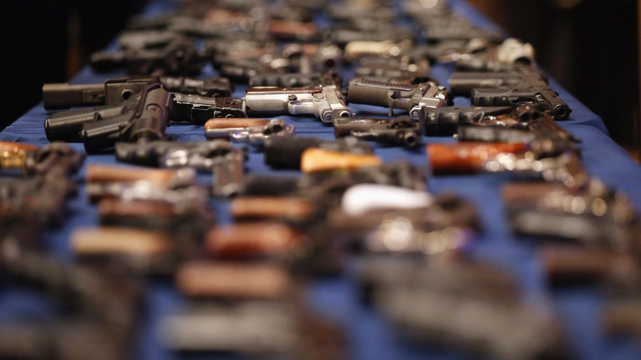 A table of illegal firearms confiscated in a large weapons bust in New York's East Harlem.