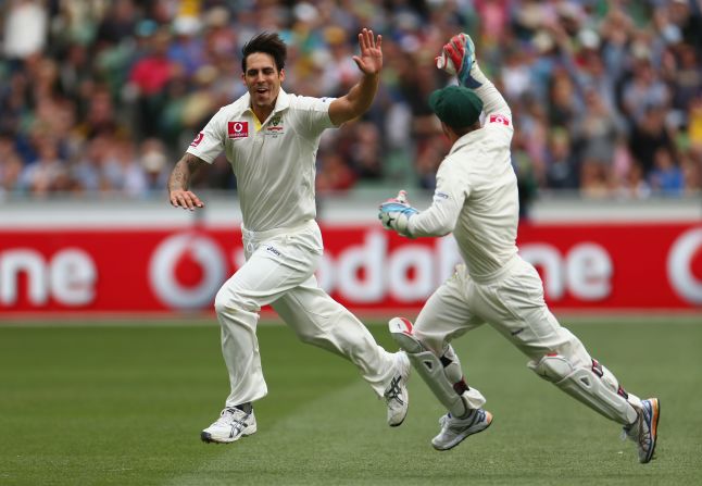 Mitchell Johnson, left, celebrates with wicketkeeper Matthew Wade after dismissing Tillakaratne Dilshan in the opening over of Sri Lanka's second innings in Melbourne.