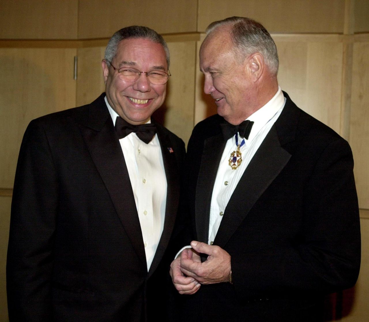U.S. Secretary of State Colin Powell talks with Schwarzkopf on December 6, 2002, during a receptionbefore the American Patriot Award Dinner in Washington. The dinner honored former U.S. President George H. W. Bush.