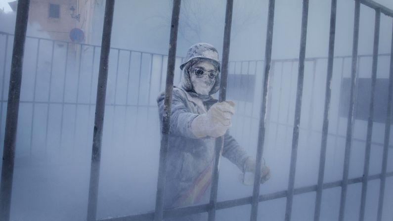 A military-dressed man stands inside a mock jail on December 28.