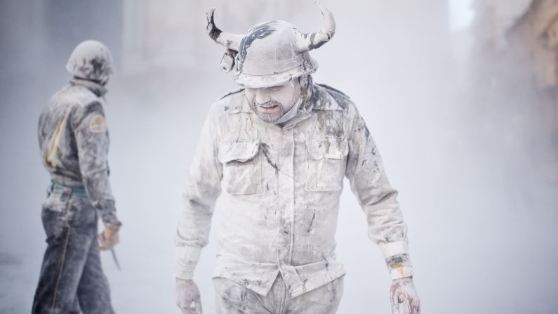 Men walk through the mock battle of Enfarinats on December 28.