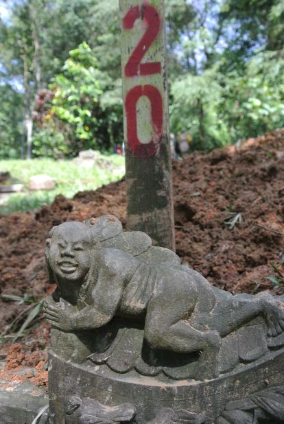A Chinese stone carving is seen on a grave marked for exhumation in Bukit Brown cemetery.  