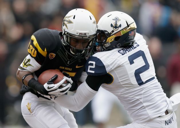 Rashad Ross of the Arizona State Sun Devils catches a touchdown pass while covered by Parrish Gaines of the Navy Midshipmen during the Kraft Fight Hunger Bowl at AT&T Park on December 29 in San Francisco.