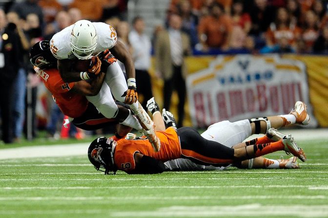 Johnathan Gray of the University of Texas Longhorns is brought down by D.J. Alexander of the Oregon State Beavers during the Valero Alamo Bowl at the Alamodome on Saturday, December 29, in San Antonio. 