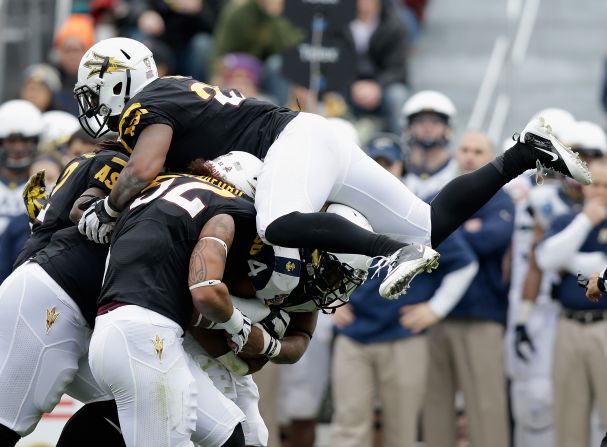 Chris Young of the Arizona State Sun Devils jumps on the pile to stop Noah Copeland of the Navy Midshipmen during the Kraft Fight Hunger Bowl.