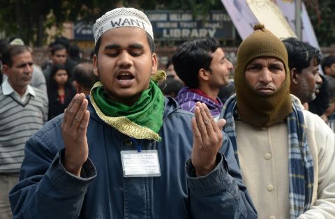 Indian residents pray during a gathering in New Delhi on December 30.