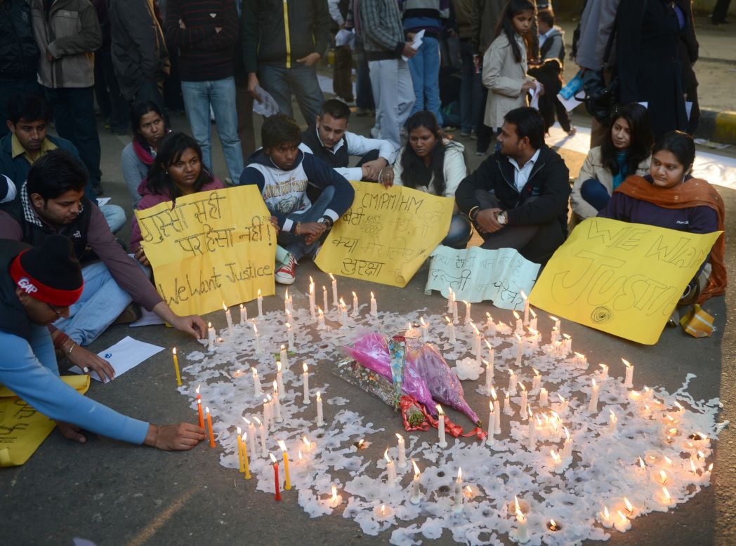 Indian protesters sit by lit candles and hold placards in New Delhi on December 30 during a protest against the gang rape.