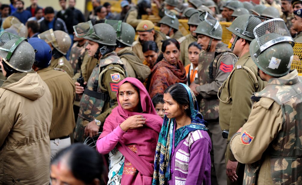 Indian protesters walk with police officials during a rally in New Delhi on Sunday, December 30, following the cremation of a gang-rape victim in the Indian capital. The 23-year-old student died Saturday and was cremated at a private ceremony, hours after her body was flown home from Singapore. She had been gang-raped and severely beaten on December 16, triggering an outpouring of grief and anger across India. 