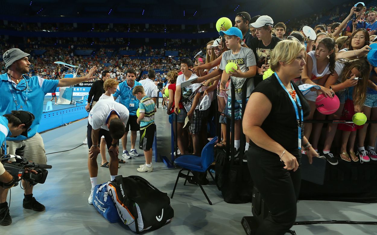 Novak Djokovic composes himself in the aftermath of an incident when a spectator barrier collapsed at the Hopman Cup.