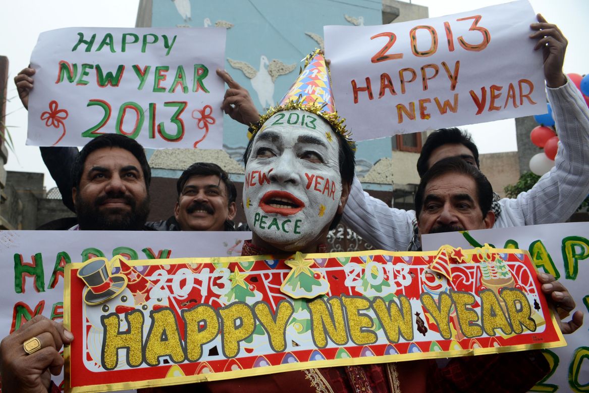 Indian revelers hold signs in Amritsar on Monday.